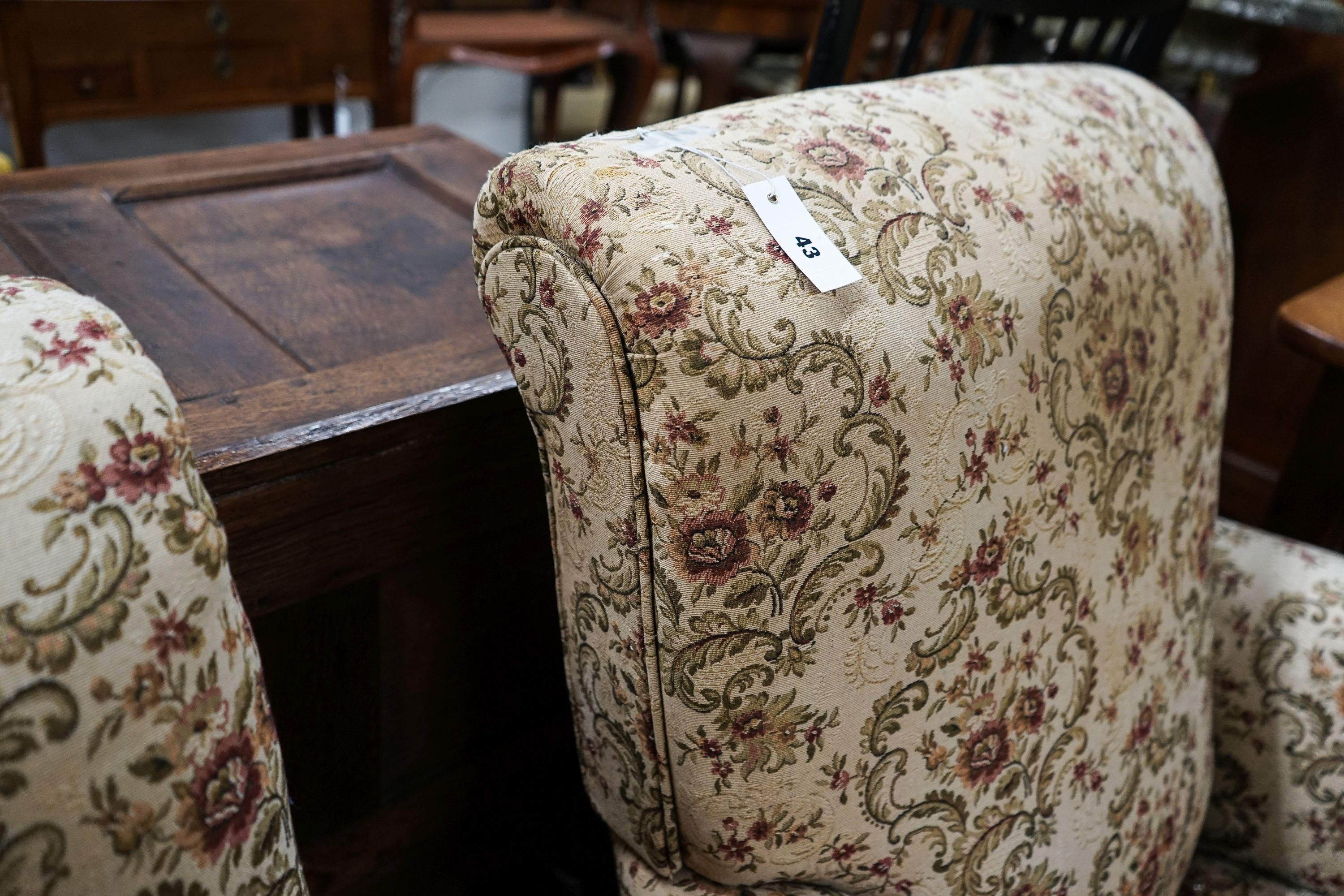 A near pair of late Victorian upholstered armchairs, width 88cm, depth 86cm, height 96cm